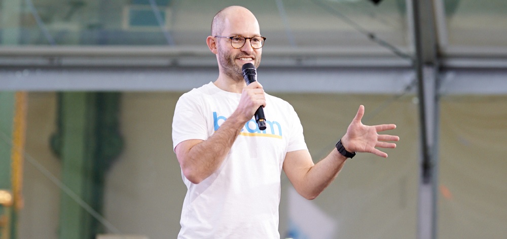 Photo of Alex Stephany, founder and CEO of Beam, speaking at an event 